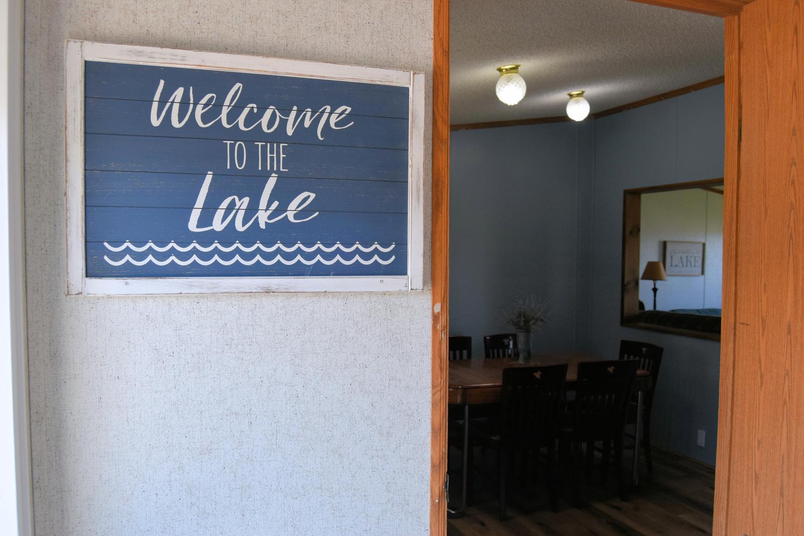 Interior view of cabin with sign saying "Welcome to the Lake"